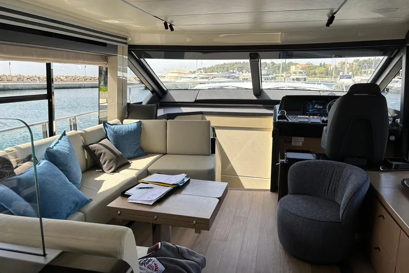  Yacht Photos Pics Luxurious interior of 2024 Absolute 60 Fly yacht with modern seating and helm.