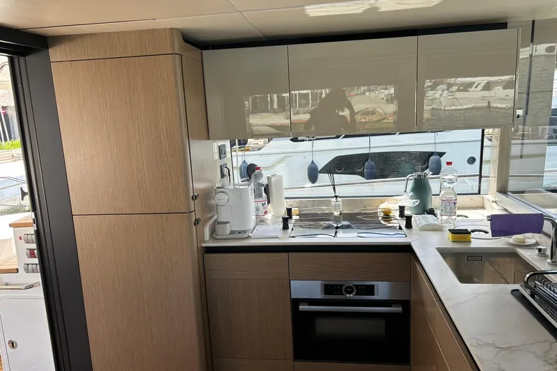  Yacht Photos Pics Modern kitchen interior on 2024 Absolute 60 Fly yacht, featuring sleek cabinetry and appliances.