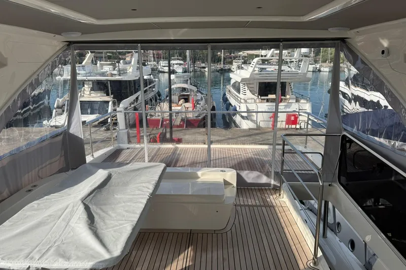  Yacht Photos Pics Interior view of 2024 Absolute 60 Fly yacht with marina backdrop.