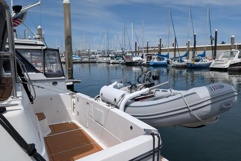 Elena Yacht Photos Pics Bayliner 4088 yacht from 2000 docked with inflatable boat, surrounded by sailboats in marina.