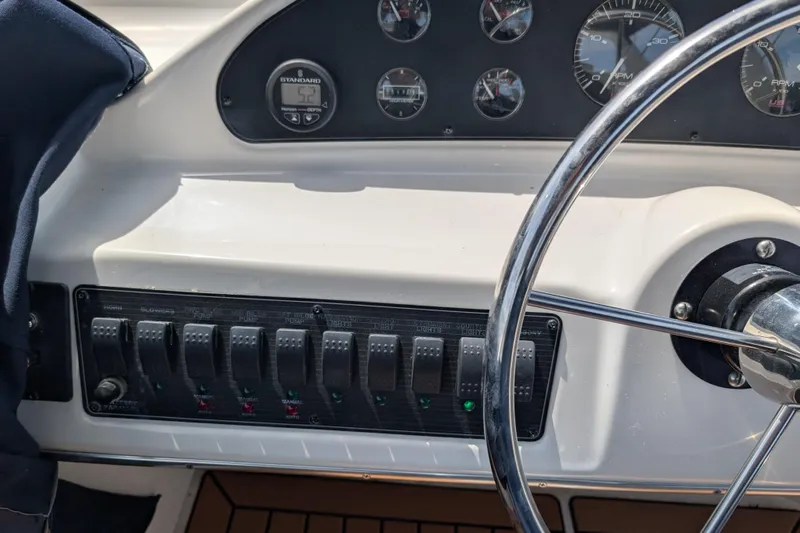 Elena Yacht Photos Pics Dashboard of a 2000 Bayliner 4088 boat with steering wheel and control panel.