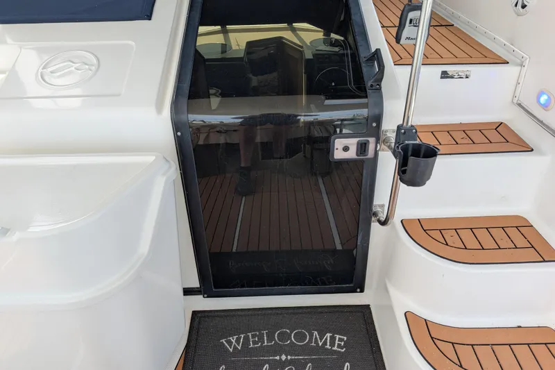 Elena Yacht Photos Pics Bayliner 4088 yacht entrance with welcome mat, teak steps, and glass door, 2000 model.