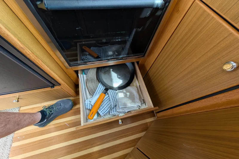 Elena Yacht Photos Pics Open drawer with kitchen utensils in a 2000 Bayliner 4088 boat interior.