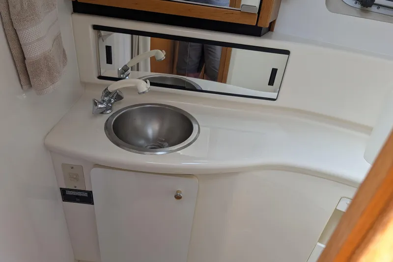 Elena Yacht Photos Pics Bayliner 4088 2000 model bathroom sink with mirror and faucet.