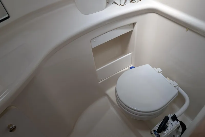 Elena Yacht Photos Pics 2000 Bayliner 4088 boat bathroom with white marine toilet and compact design.