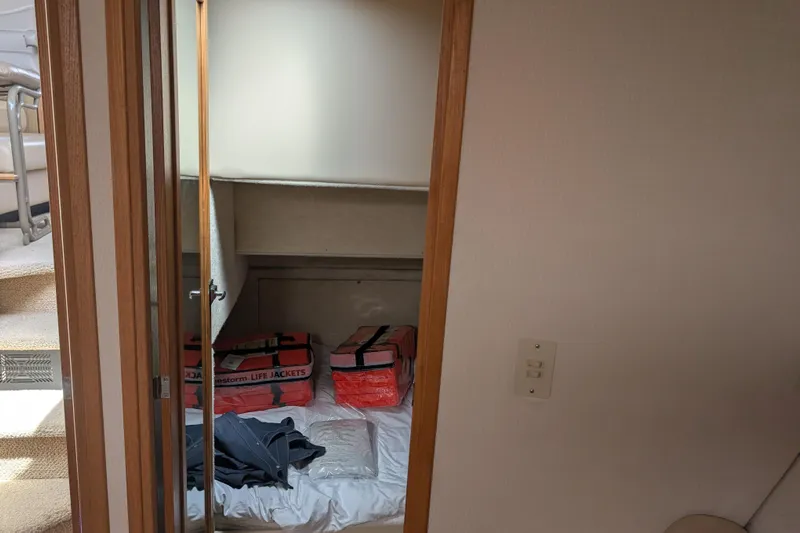 Elena Yacht Photos Pics Interior cabin of 2000 Bayliner 4088 with life jackets and bedding.