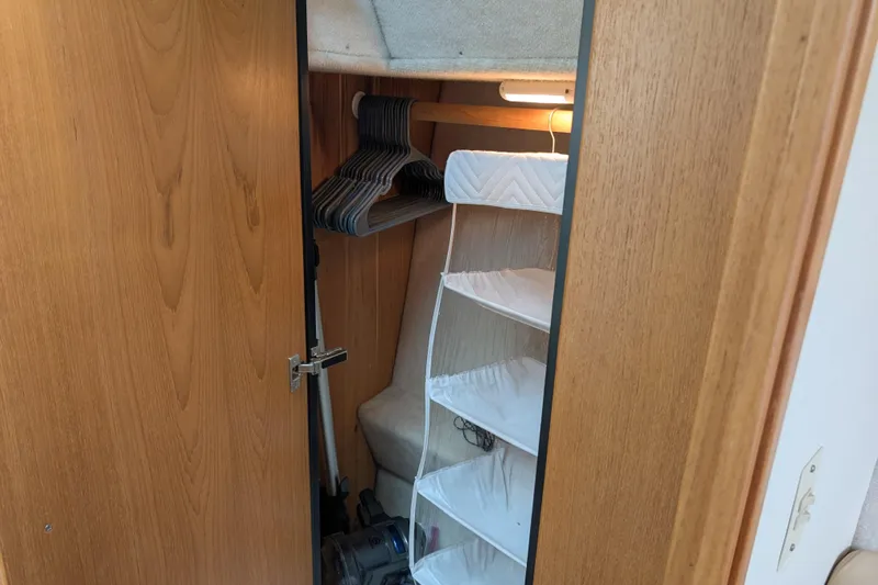 Elena Yacht Photos Pics Bayliner 4088 2000 model closet with hangers and storage shelves.