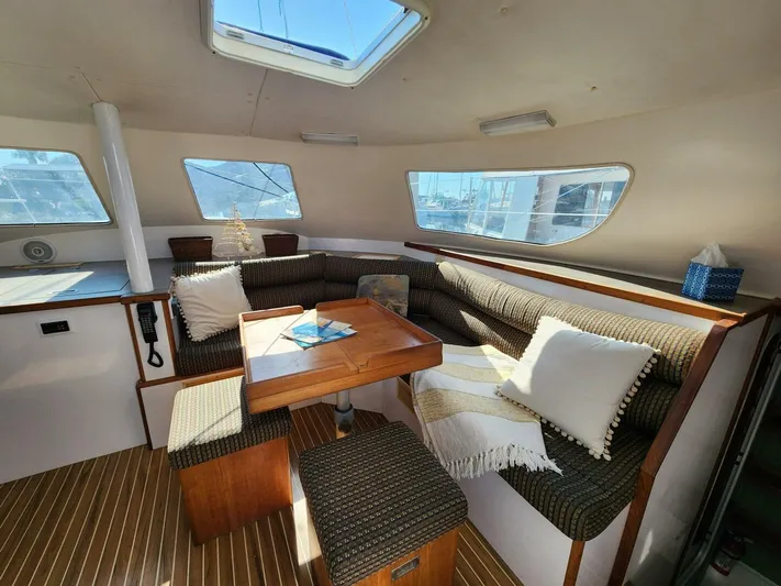  Yacht Photos Pics Interior of 2000 Manta 42 catamaran with cozy seating and wooden table.