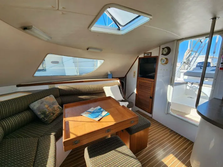  Yacht Photos Pics Interior of 2000 Manta 42 yacht with cozy seating and wooden table.
