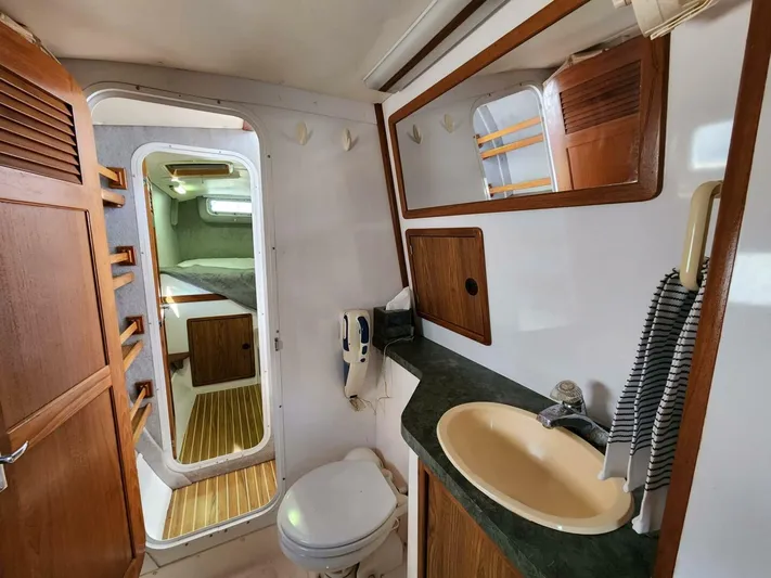  Yacht Photos Pics Manta 42 yacht bathroom with sink, toilet, and wooden cabinetry, 2000 model.