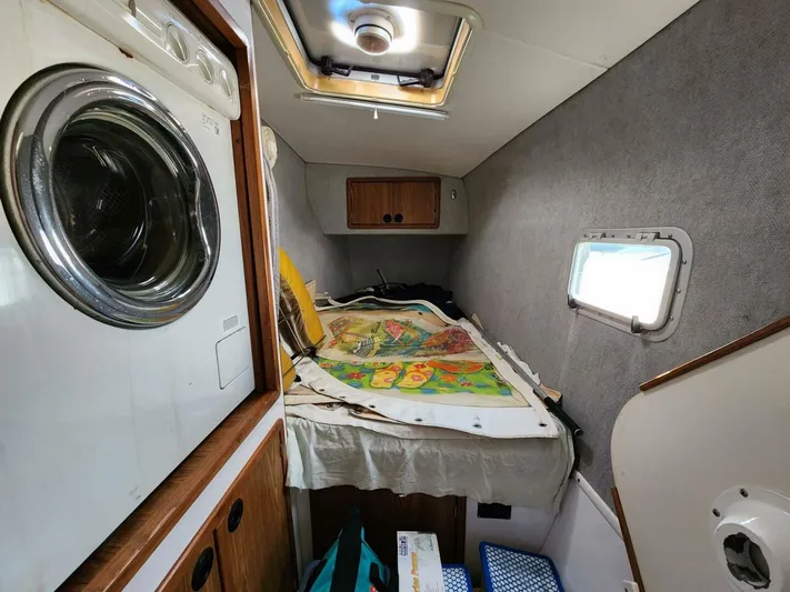  Yacht Photos Pics Interior of a 2000 Manta 42 sailboat cabin with a washing machine and colorful map.