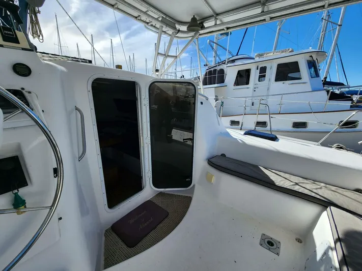  Yacht Photos Pics 2000 Manta 42 sailboat cockpit with seating and helm, docked at marina.