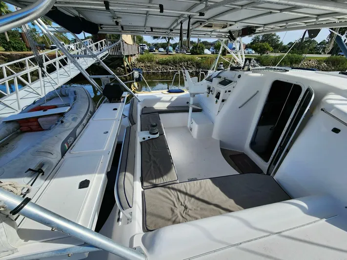  Yacht Photos Pics Manta 42 catamaran cockpit, 2000 model, with seating and helm, docked by the water.