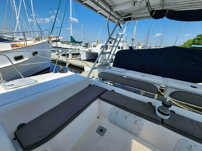  Yacht Photos Pics Manta 42 sailboat cockpit, 2000 model, docked in a marina with other boats.