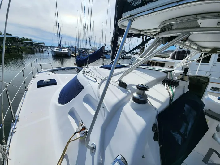  Yacht Photos Pics Manta 42 sailboat, 2000 model, docked in marina with other boats.