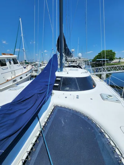  Yacht Photos Pics Sailboat Manta 42, 2000 model, docked at marina under clear blue sky.