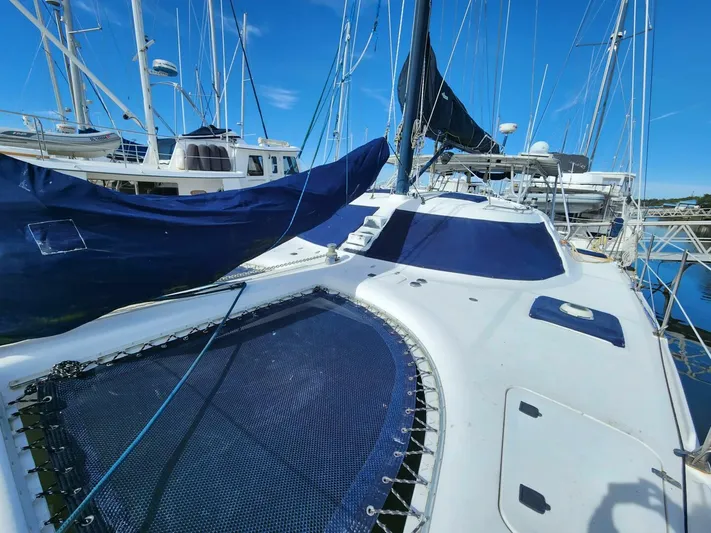  Yacht Photos Pics Manta 42 catamaran, 2000 model, docked in marina with blue sails and netting.