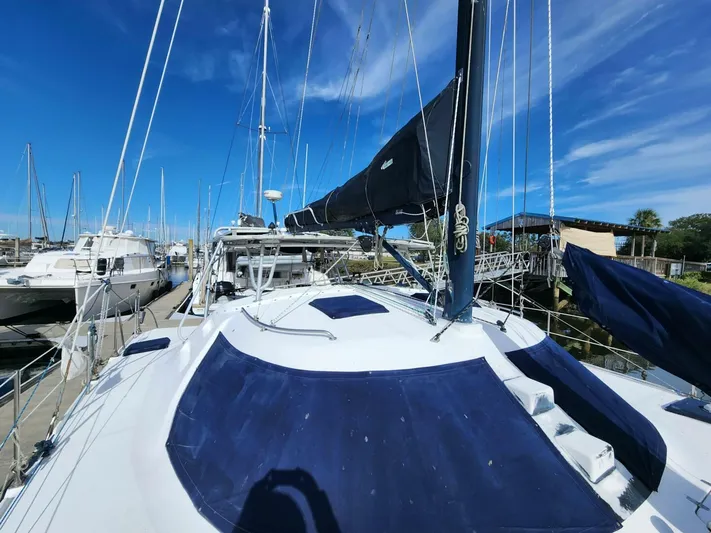  Yacht Photos Pics Sailboat Manta 42, 2000 model, docked at marina under clear blue sky.