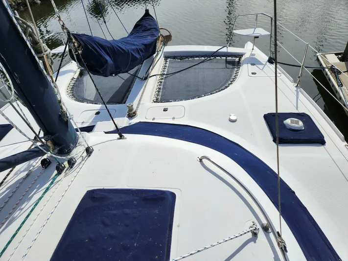  Yacht Photos Pics Sailboat deck of 2000 Manta 42 catamaran with blue accents and netting.
