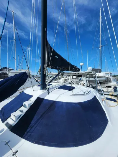  Yacht Photos Pics Sailboat Manta 42, 2000 model, docked with blue sails under clear sky.