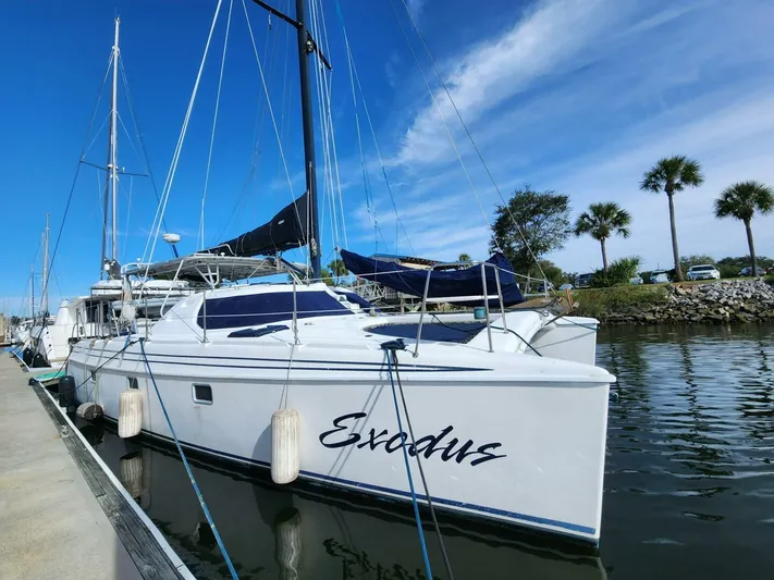  Yacht Photos Pics Manta 42 catamaran docked, named "Exodus," under clear blue sky.