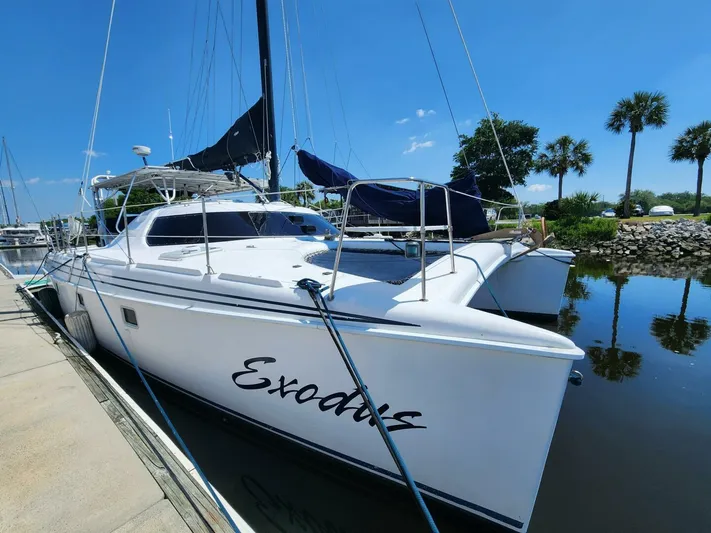  Yacht Photos Pics Manta 42 catamaran docked, 2000 model, named "Exodus," under clear blue sky.