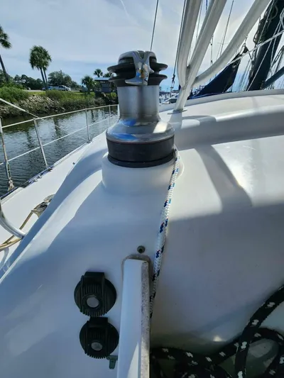  Yacht Photos Pics Sailboat deck with winch and ropes, Manta 42, 2000 model, docked near palm trees.