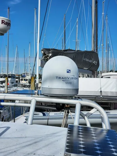  Yacht Photos Pics Manta 42 sailboat with TracVision satellite, marina background, clear blue sky.