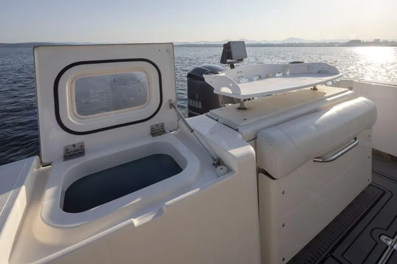 Salt Yacht Photos Pics 2009 Pursuit 345 Offshore OS boat with open storage compartment on calm water.