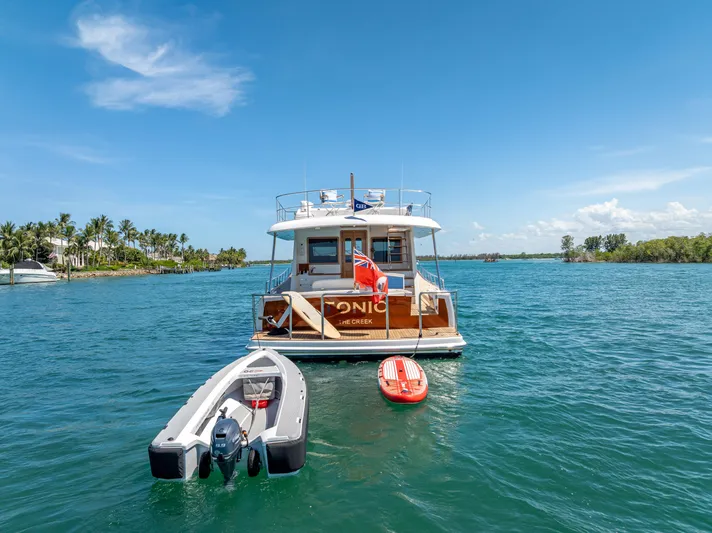 Tonic Yacht Photos Pics 2018 Grand Banks GB60 yacht on water with dinghy and paddleboard.