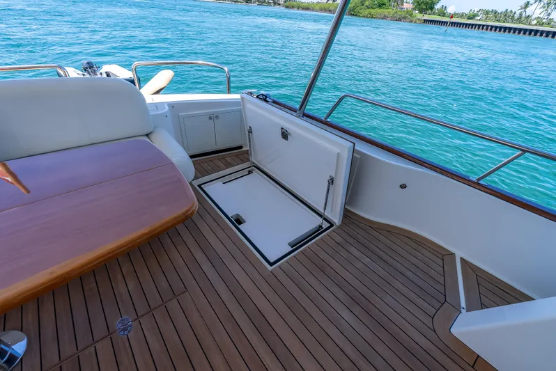 Tonic Yacht Photos Pics 2018 Grand Banks GB60 yacht deck with open hatch, wooden flooring, and ocean view.
