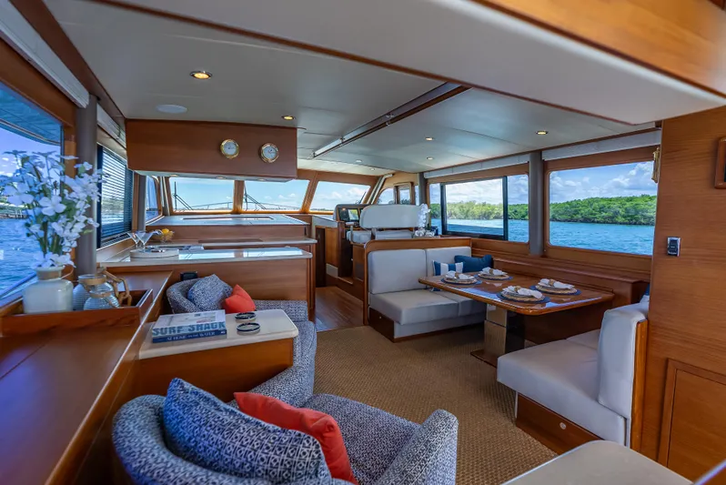 Tonic Yacht Photos Pics Luxurious interior of 2018 Grand Banks GB60 yacht with elegant dining area and scenic ocean views.