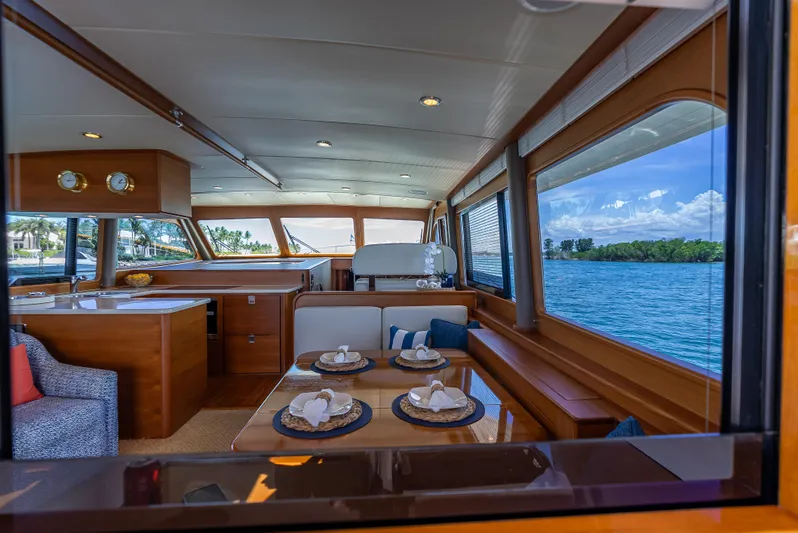 Tonic Yacht Photos Pics Luxurious 2018 Grand Banks GB60 yacht interior with elegant dining area and scenic ocean view.