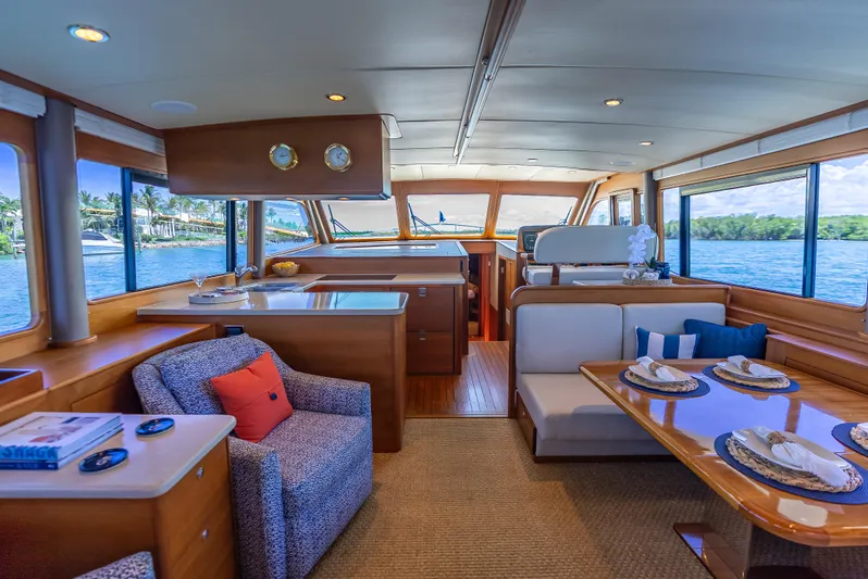 Tonic Yacht Photos Pics Luxurious 2018 Grand Banks GB60 yacht interior with elegant dining and seating area, ocean view.