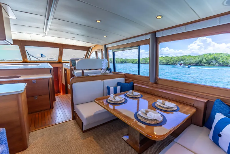 Tonic Yacht Photos Pics Luxurious 2018 Grand Banks GB60 yacht interior with elegant dining area and scenic ocean view.