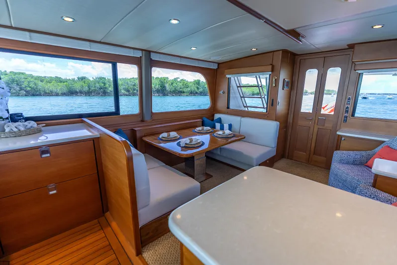 Tonic Yacht Photos Pics Luxurious 2018 Grand Banks GB60 yacht interior with dining area and scenic water views.