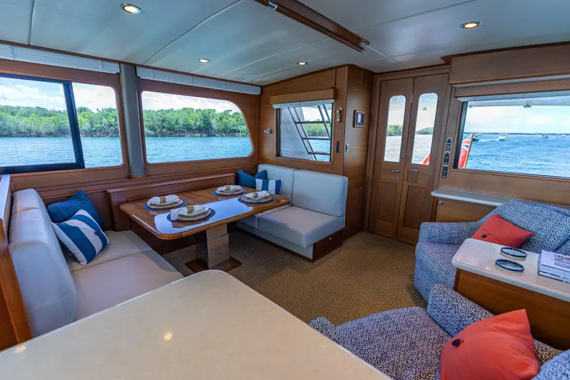 Tonic Yacht Photos Pics Luxurious 2018 Grand Banks GB60 yacht interior with elegant dining area and scenic water views.