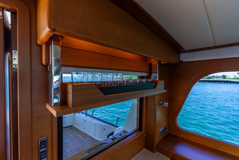 Tonic Yacht Photos Pics Luxurious interior of 2018 Grand Banks GB60 yacht with elegant wood finish and ocean view.