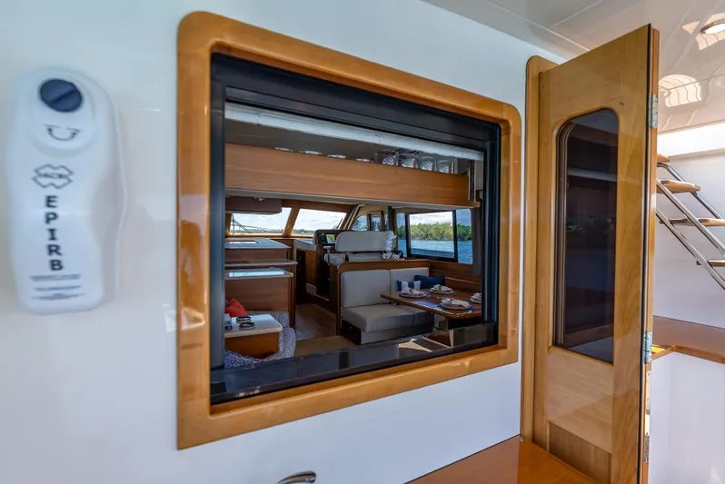 Tonic Yacht Photos Pics Interior view of 2018 Grand Banks GB60 yacht, featuring elegant wood finishes and dining area.