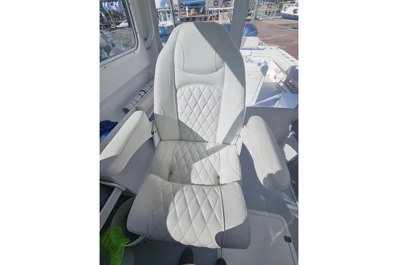  Yacht Photos Pics Captain's chair on 2021 Steiger Craft 31 Miami boat, featuring quilted upholstery.