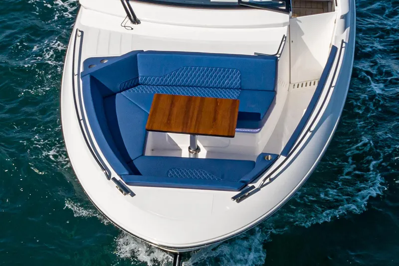 On Its Way Yacht Photos Pics 2024 Bavaria Vida 33 boat with blue seating and wooden table on deck.