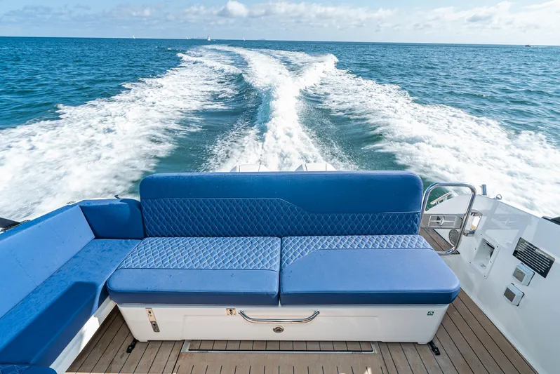 On Its Way Yacht Photos Pics 2024 Bavaria Vida 33 boat with blue seating, cruising on open water.