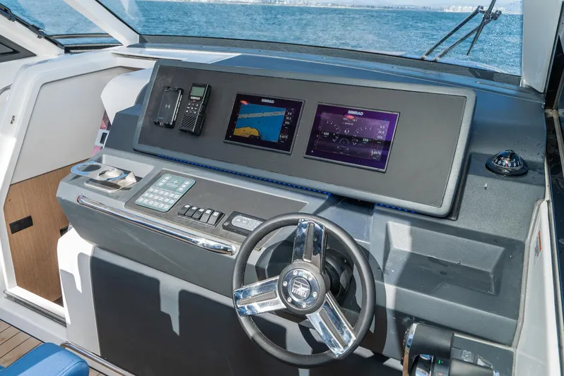 On Its Way Yacht Photos Pics 2024 Bavaria Vida 33 yacht dashboard with modern navigation displays and steering wheel.