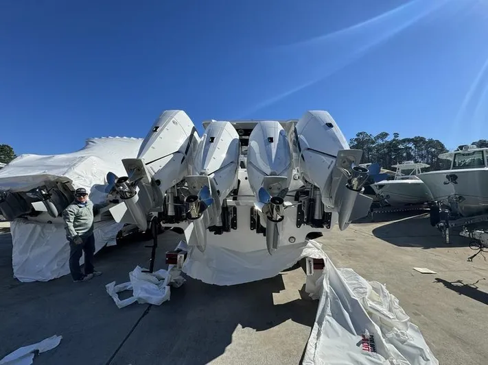  Yacht Photos Pics 2024 Fountain 38 SCX boat with multiple outboard engines in a marina.