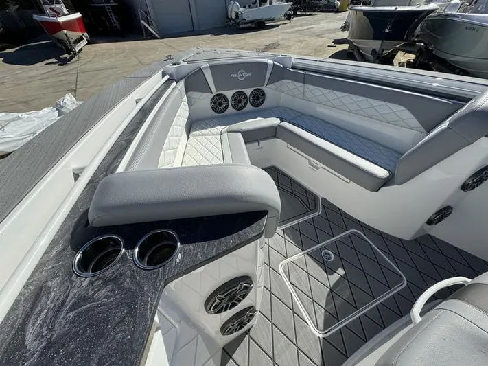  Yacht Photos Pics 2024 Fountain 38 SCX boat interior with cushioned seating and cup holders.