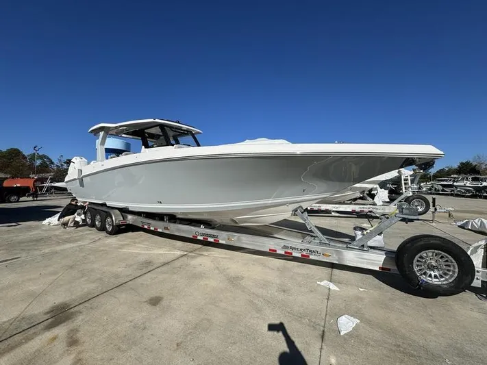  Yacht Photos Pics 2024 Fountain 38 SCX boat on a trailer in a marina.