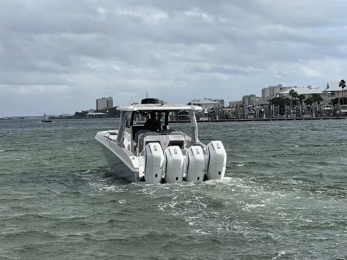  Yacht Photos Pics 2024 Fountain 38 SCX boat with four outboard engines cruising on a cloudy day.