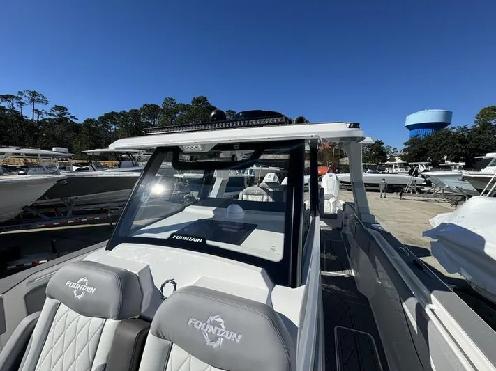  Yacht Photos Pics 2024 Fountain 38 SCX boat with sleek design and luxurious seating.