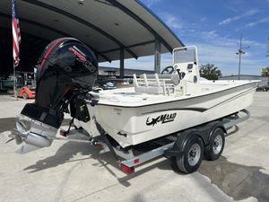 2024 Mako Pro Skiff 19 CC boat with Mercury engine on trailer, outdoor setting.