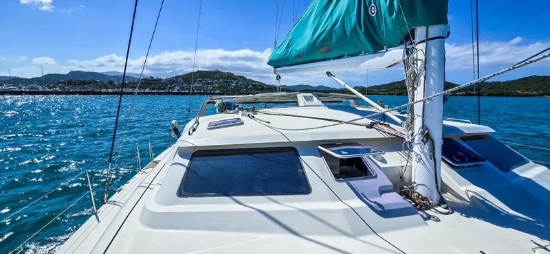 Makai Yacht Photos Pics Sailing on a 1997 Voyage Mayotte 50 catamaran in clear blue waters.